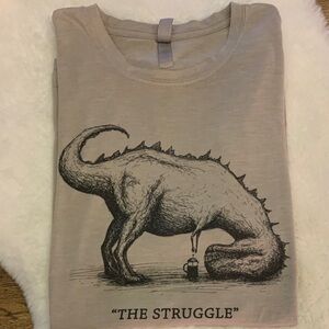 “The Struggle” Women’s XL Soft Light Graphic Tee with Dinosaur Print